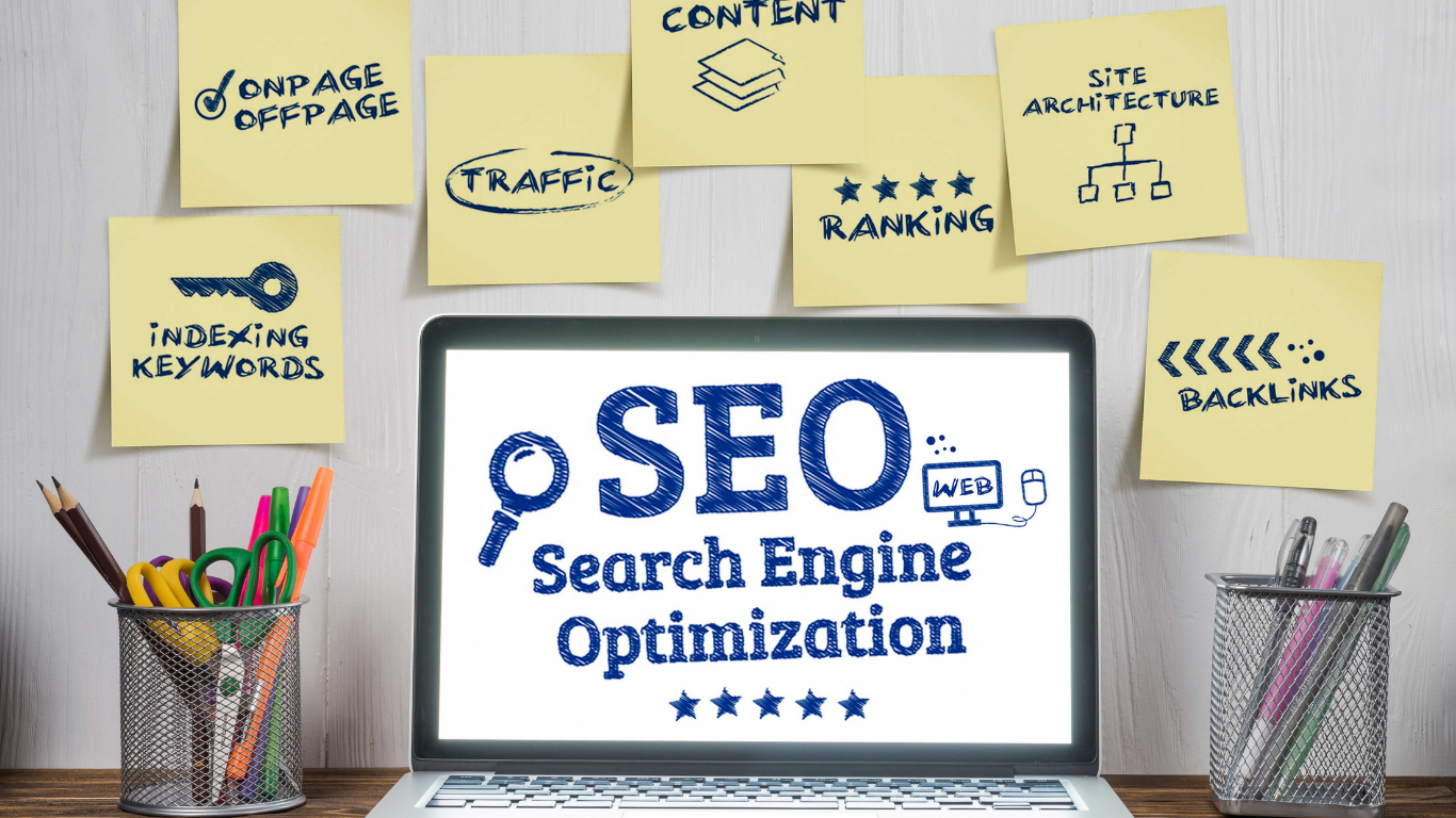 Laptop screen displaying "SEO Search Engine Optimization" surrounded by sticky notes with SEO-related terms like content, backlinks, keywords, traffic, and more.